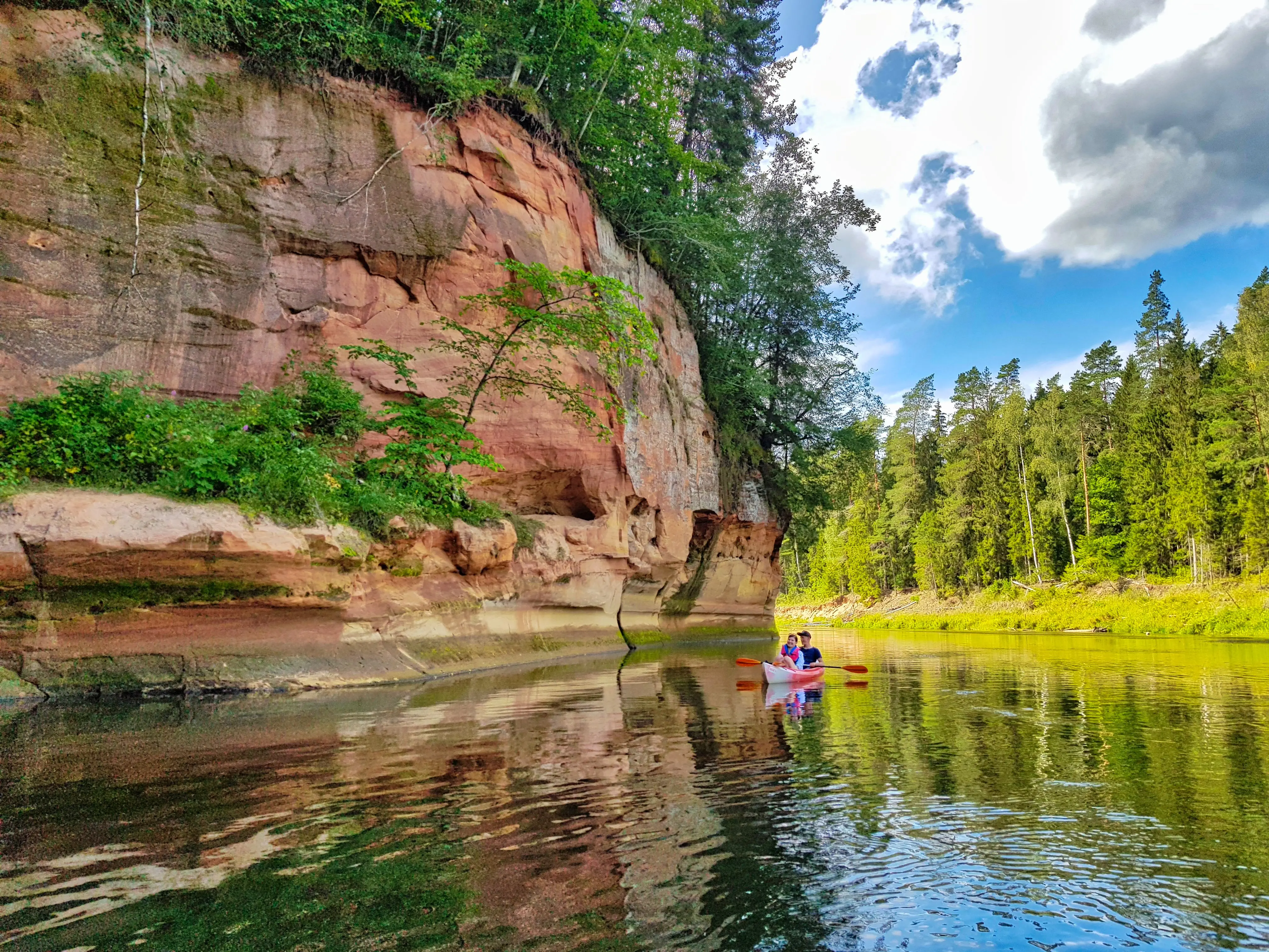Kayaking in Gauja River Sandstone cliff  photo by Rolands Ratfelders